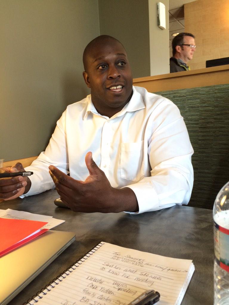 Omari Walker explains our model to a prospective staff member.