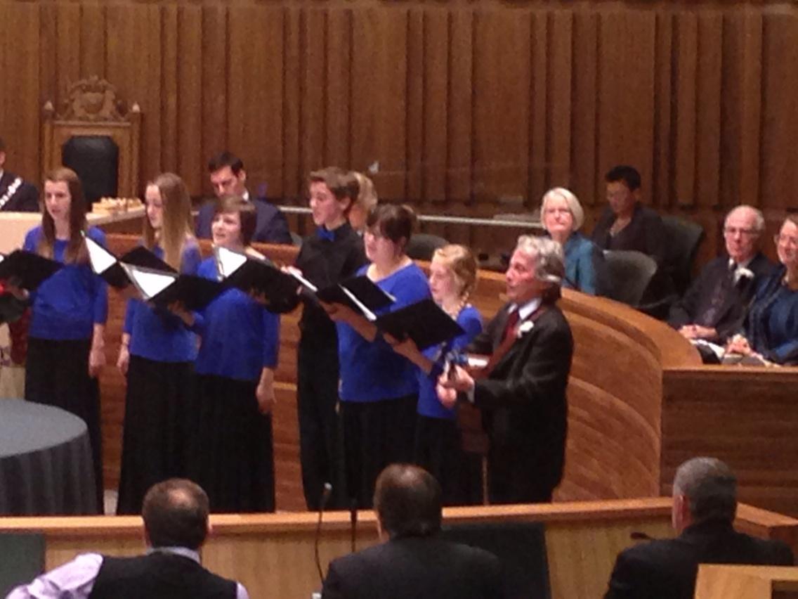 Councillor James Gordon joins the Guelph Youth Singers in singing Our City - a song he wrote himself.