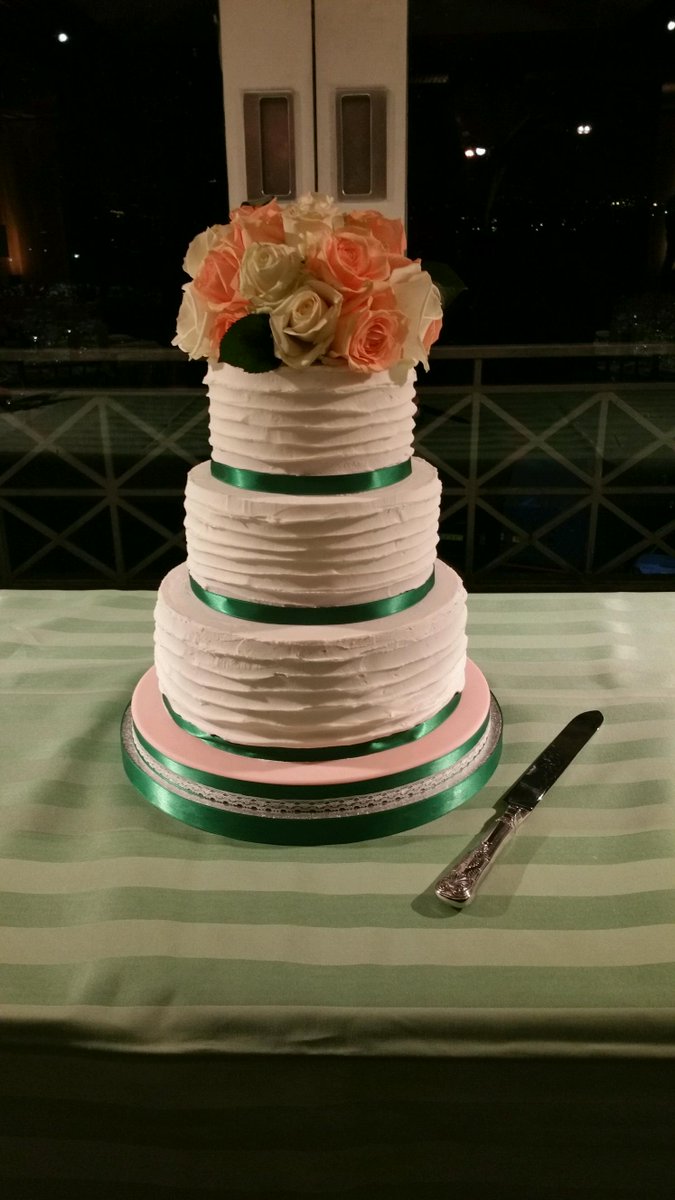 Three tiered fruitcake with fresh flowers.