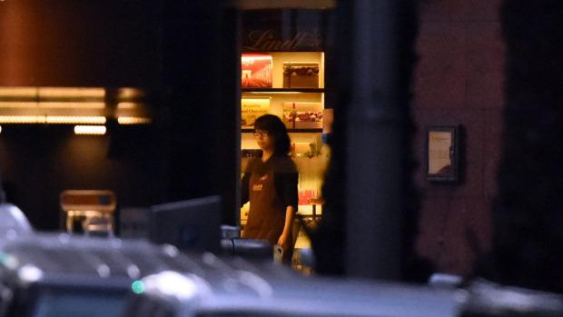 smh's tweet photo. Female hostage appears to turn off the lights at the Lindt Cafe tonight. http://t.co/T6qUZxSrTe #sydneysiege http://t.co/p0p9TYLyeO