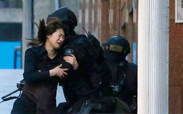 Telegraph's tweet photo. Two women flee #sydneysiege cafe http://t.co/BqHdeSc9Iu via @telegraphvideo http://t.co/iqsGuhpUBG