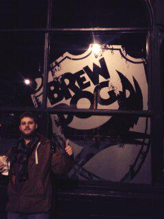 Xylouk's tweet image. Here's our trusty bassist lew (the brew) dog standing outside his favourite place.