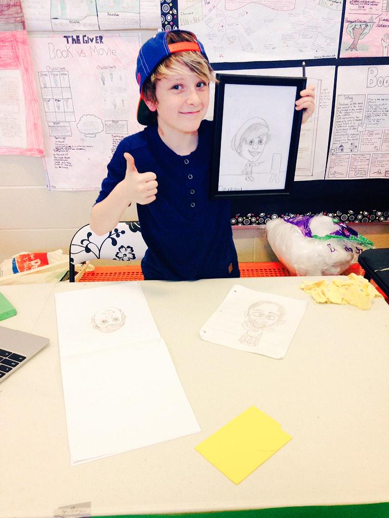 DanaAriss's tweet photo. His caricature booth is all set up! Now working on varying his art for #iweek5 . #psd70gcms #psd70 http://t.co/nHn4LGMWK1