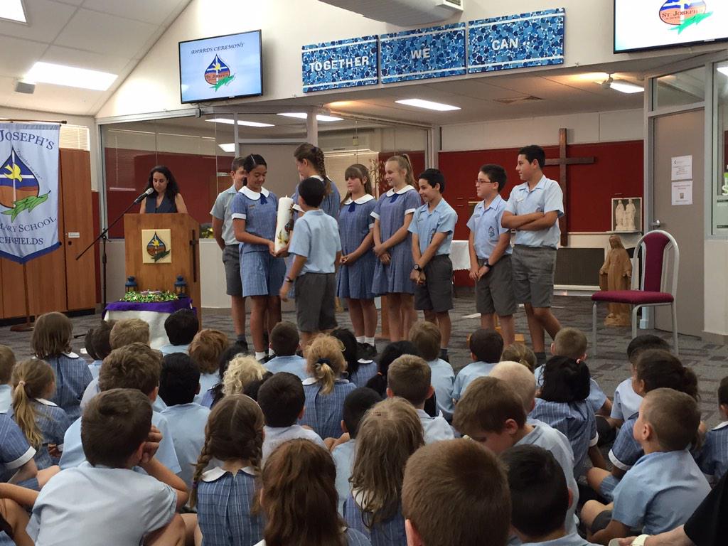 SJSyr62014's tweet photo. The Year 6 #schoolcaptains and leaders of 2014 handing over the school candle to the school captains of 2015 @SJSyr5 http://t.co/kLdnhKBWNu