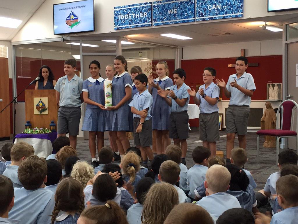 SJSyr62014's tweet photo. The Year 6 #schoolcaptains and leaders of 2014 handing over the school candle to the school captains of 2015 @SJSyr5 http://t.co/kLdnhKBWNu