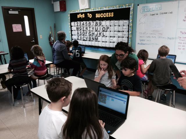 First graders engaged in "Pair Programming" for Hour of Code in the Bryker Woods' new STEAM lab!