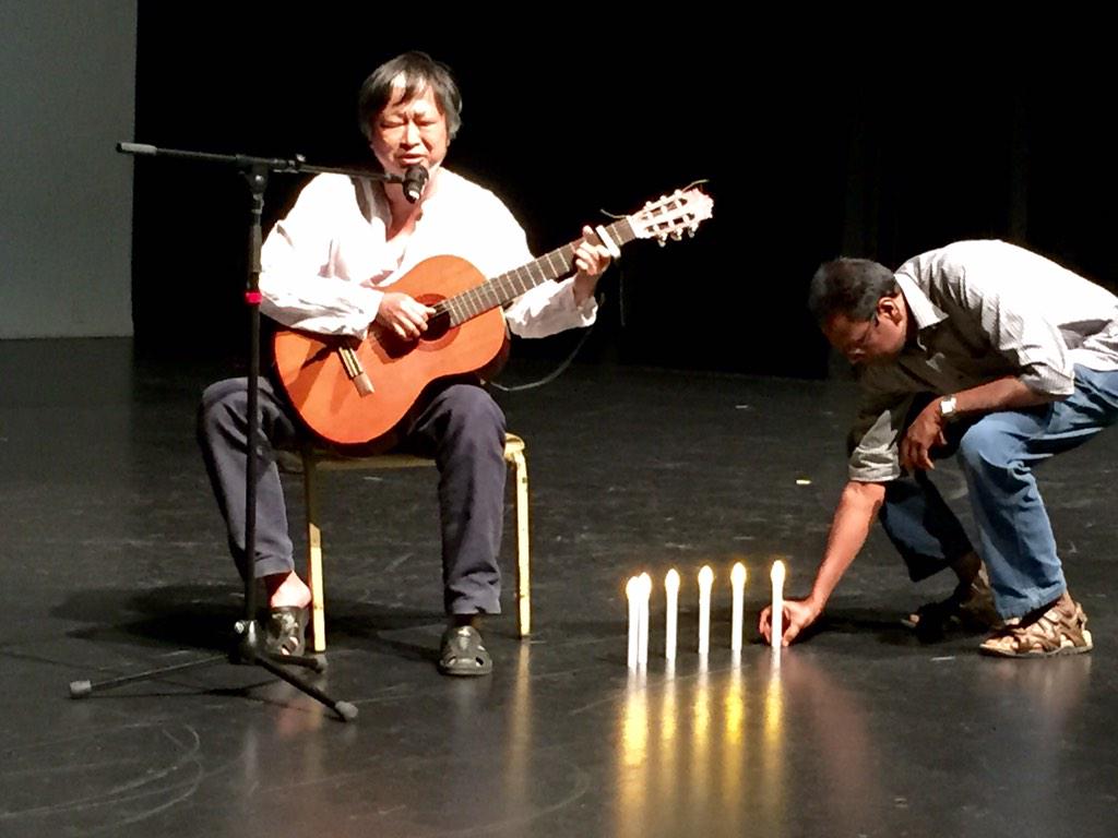 John Kee sings his plea 4 rights 4 all amid candles for #HumanRightsDay @ Romero Centre vigil #RestoreTheirRights