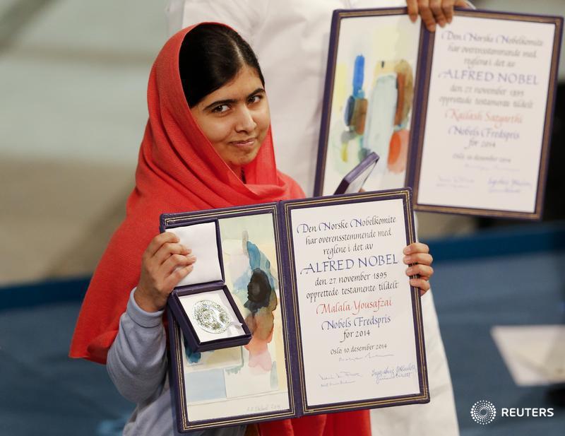 Malala Yousafzai poses with her medal at the Nobel Prize awards ceremony. Editor's Choice: reut.rs/1wyDYYm
