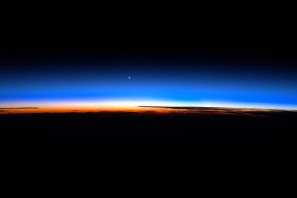 NASA's tweet photo. From @AstroTerry on @Space_Station: 'Venus sits on the background of the Earth's atmosphere.' #ISS http://t.co/3Ti0v2nEWr