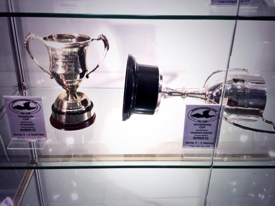 FCBurray's tweet photo. Thompson and Oxy cup in the display cabinet at Picky. Limited room on the shelve, hopefully not in the A league! #BFC http://t.co/f2EV5YmTiY