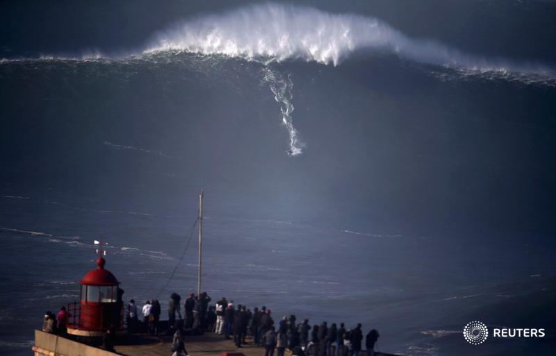 Reuters's tweet image. A surfer drops in on a large wave at Praia do Norte. Editor's Choice photos: reut.rs/1yGRSTb