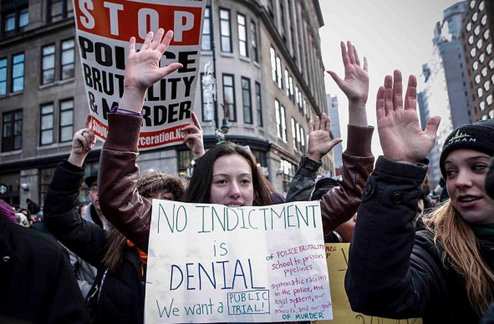 NPRCodeSwitch's tweet photo. Faces from today's on-going #MillionsMarchNYC rally. http://t.co/68Fnj3SNnh via @nprnews (pics via @GettyImages) http://t.co/u1vRge5sAz