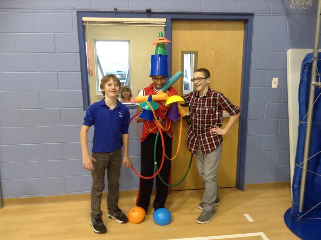Decorating trees.  Groups of 3 taking turns relay style to decorate the tree.