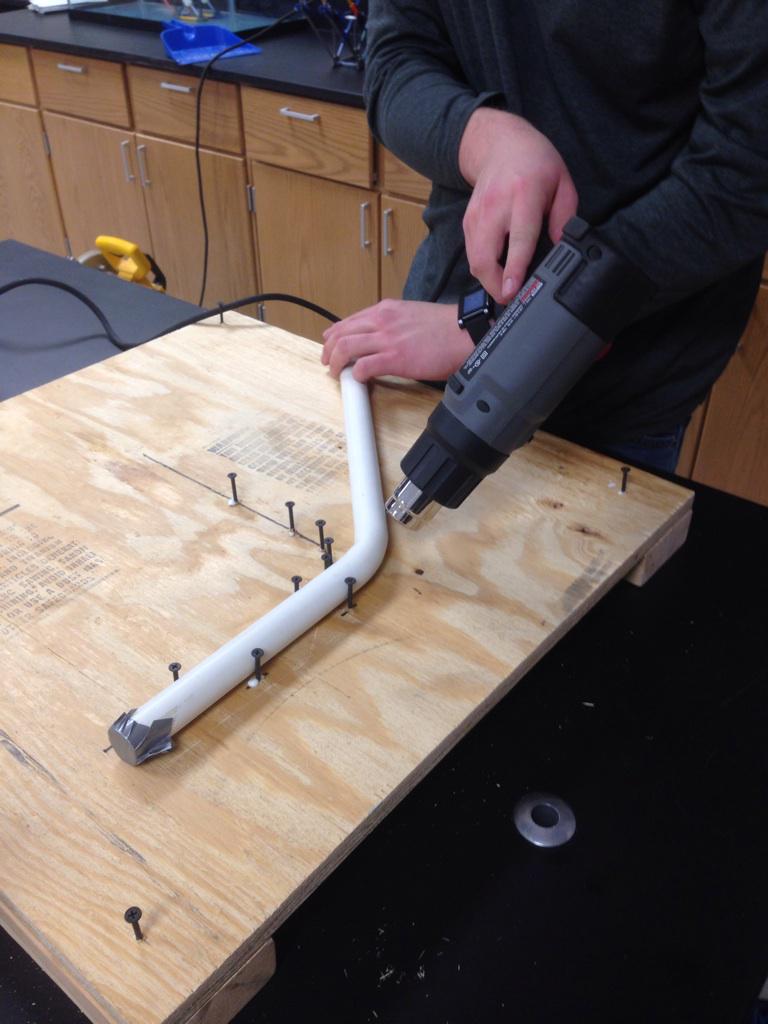 Using a heat gun to bend our bot's frame