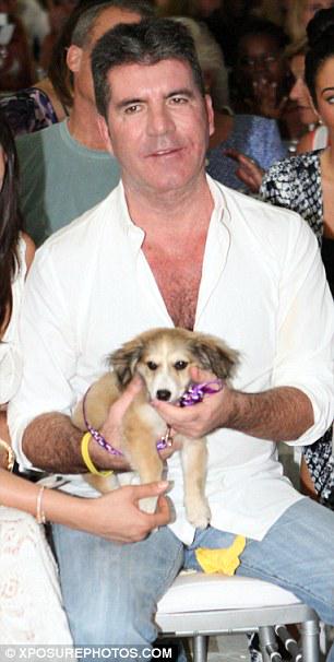 JustSimonCowell's tweet photo. Simon Cowell, Lauren &amp; guests attend a dog charity auction in Barbados. More puppy photos: http://t.co/CigSnGXXBI http://t.co/x0LRpZx9i0