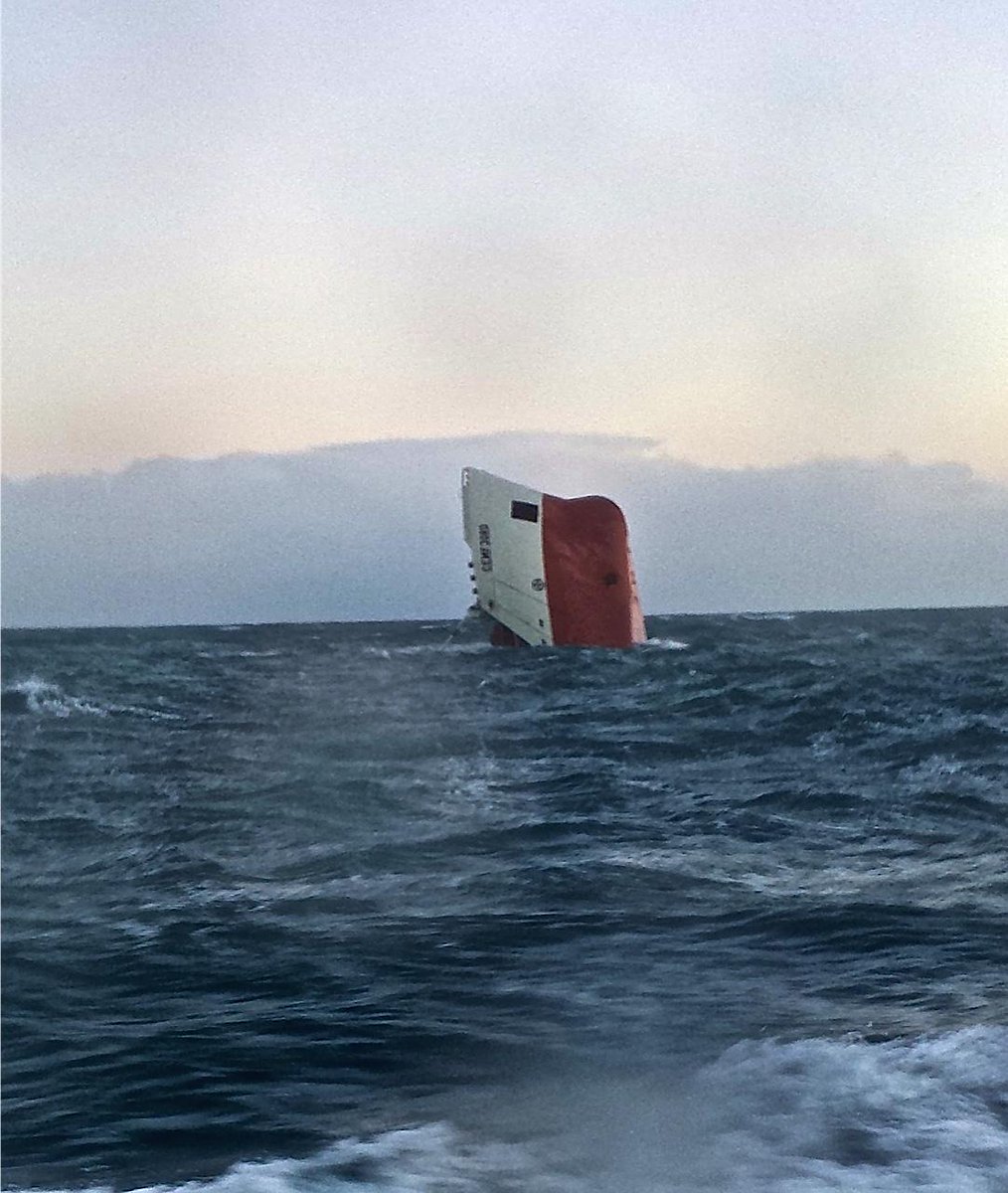 RNLI's tweet photo. PHOTO: @wicklifeboat stands by upturned cargo ship while Longhope, @ThursoRNLI and Stromness lifeboats search area. http://t.co/GoYHjOyXOX