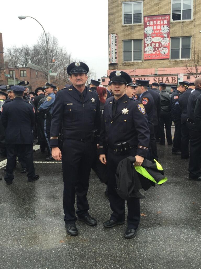 Officers Aldred and Ceasaretti in New York among thousands of law enforcement officers attending NYPD funeral.