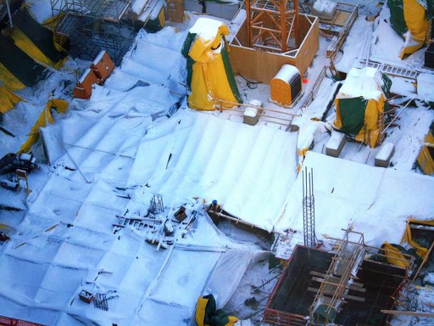 IceDistrict's tweet image. A healthy layer of snow covers the site, but work continues on the first EAD office tower!