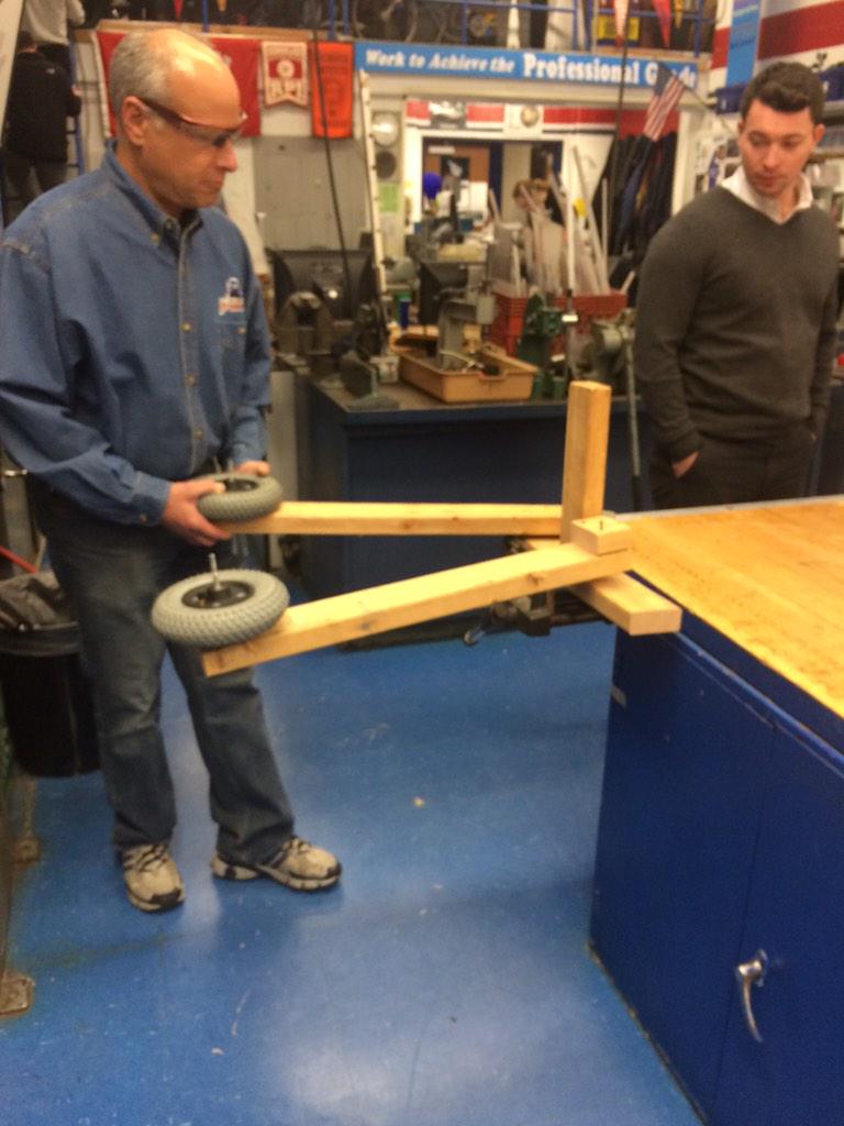 POBots_353's tweet photo. We have an intake prototype. Spring hinged arm with a motor driven wheel in the front. #2015FRCGame #POBots http://t.co/K1Mxijkary