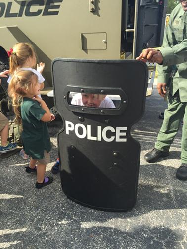 Alpha tries on the police shield @StPetePD #ExperientialSchool