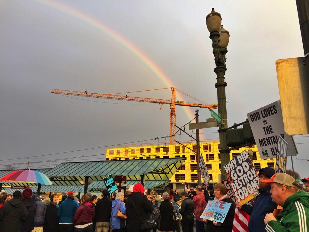 vickybeeching's tweet image. Arrived just now at #GCNConf to a loud crowd of Westboro Baptist protestors..and to a giant rainbow above them.