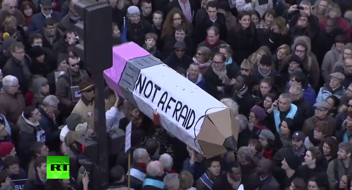 RT_com's tweet photo. 'Not Afraid!' #ParisMarch participants carry huge pencil symbolizing freedom of expression http://t.co/bC6K3qJBWd http://t.co/rkmvpWNPYM
