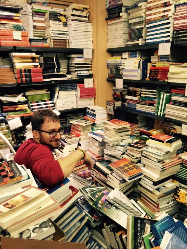 usfcabookstore's tweet image. Our associate Max is drowning in a sea of text books! #springsemesterprep
