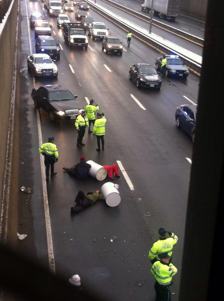 StacoS's tweet photo. [NOW] #boston #BlackLivesMatter protesters, attached to 1200 lb barrels on I-93 N/B #QuincyMA to shut down highway http://t.co/1JaGjvmcM3