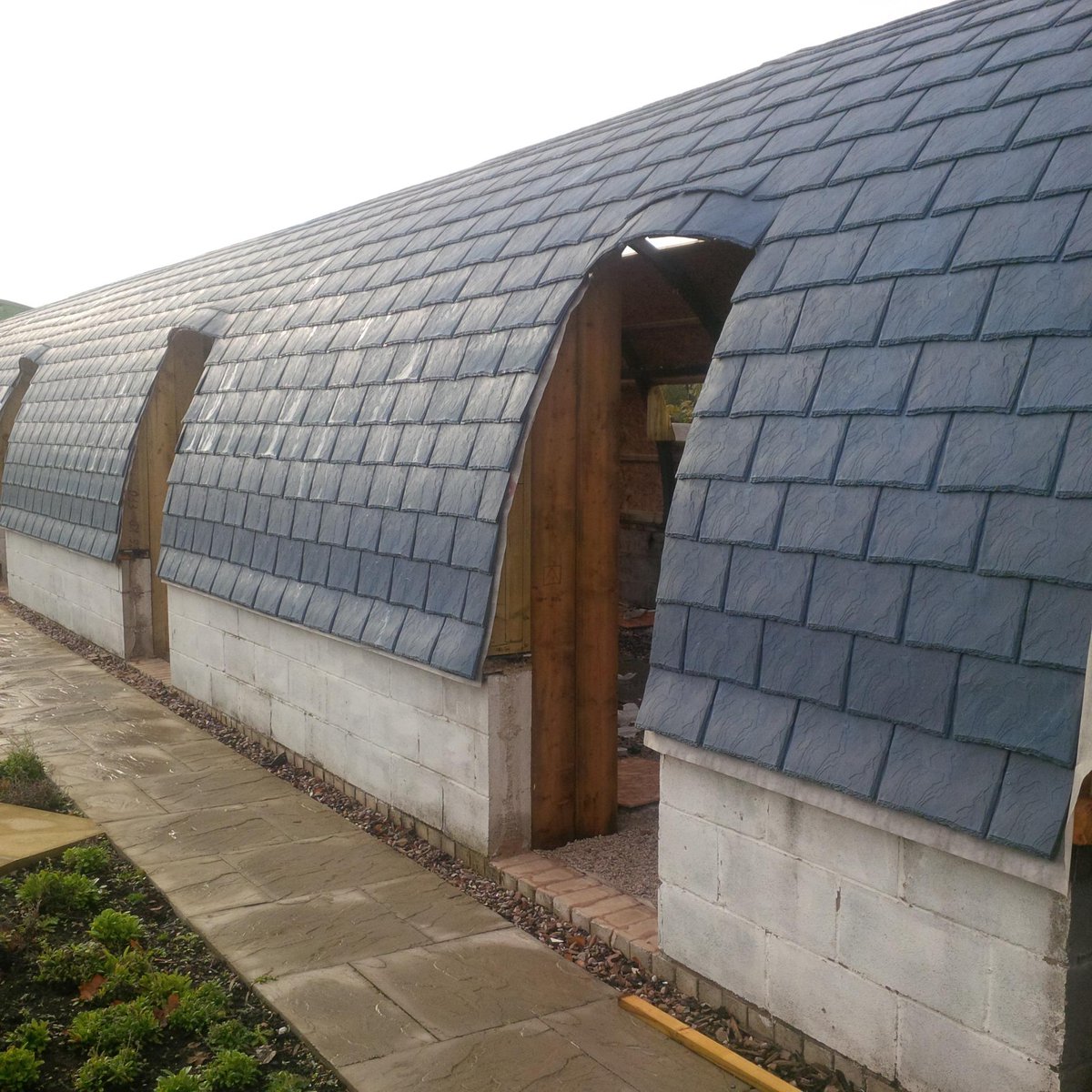 EcoDecking's tweet photo. Our Eco Slates on a Curved Building #pod #campingpod #logcabin http://t.co/HiUZ4v3dwQ