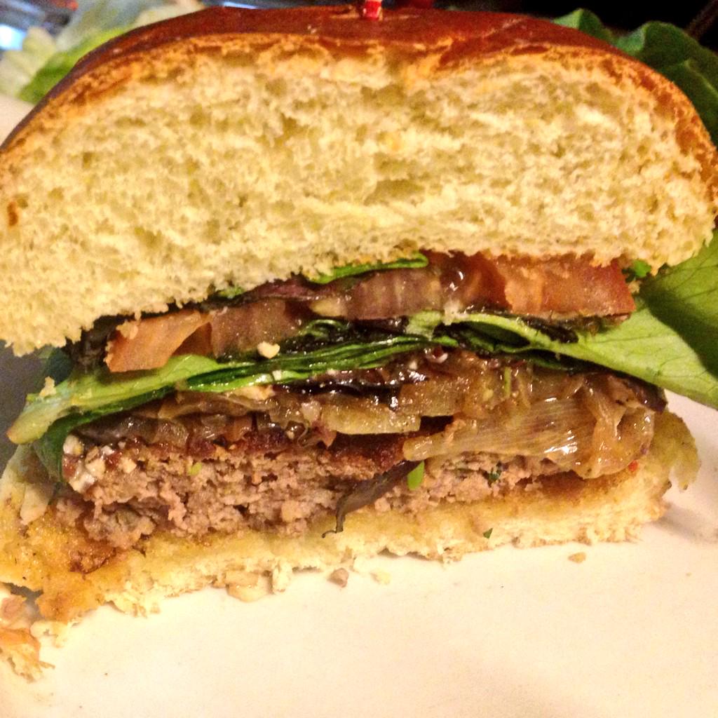 This weekend special Lamb/brisket burger blended in house with feta butter, mixed greens, grilled onion and tomato