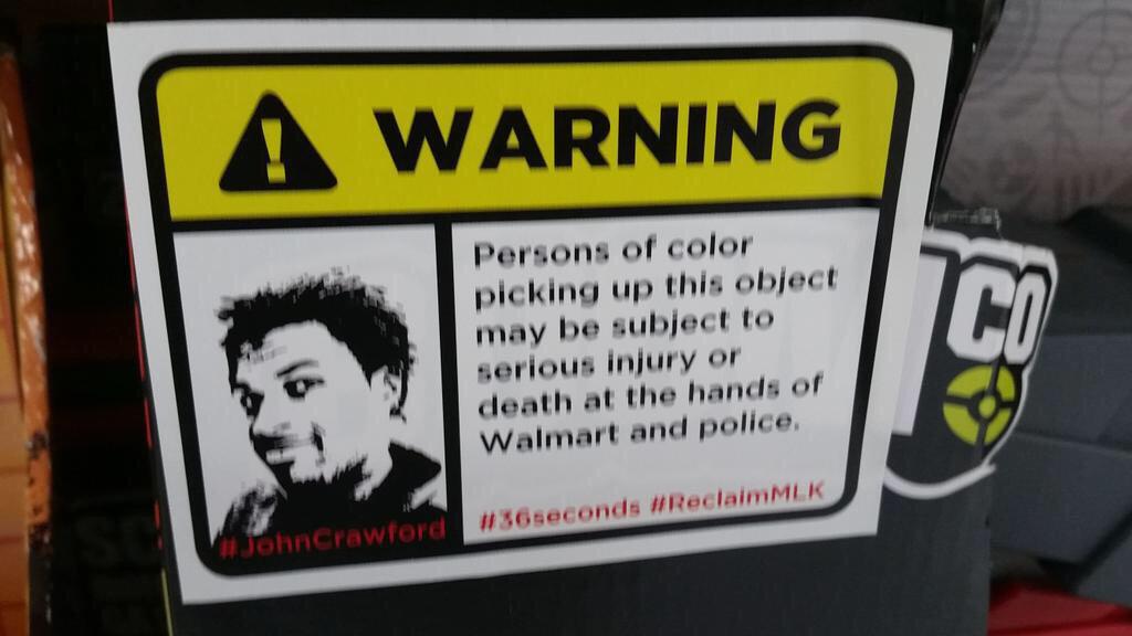 SoSharpiSlay's tweet photo. RT “@bassem_masri: Organizers put warning labels on #walmart products warning them of the dangers RIP #JohnCrawford http://t.co/fo6CSezW6r”
