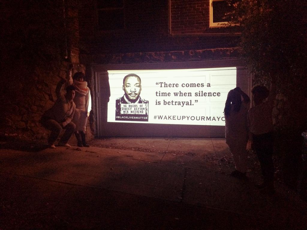 Jay_Marie's tweet photo. Projection Action on @libbyformayor's garage. If we can't breathe, you can't DREAM. #ReclaimMLK #wakeupyourmayor  #fb http://t.co/LvHzLtOxJR