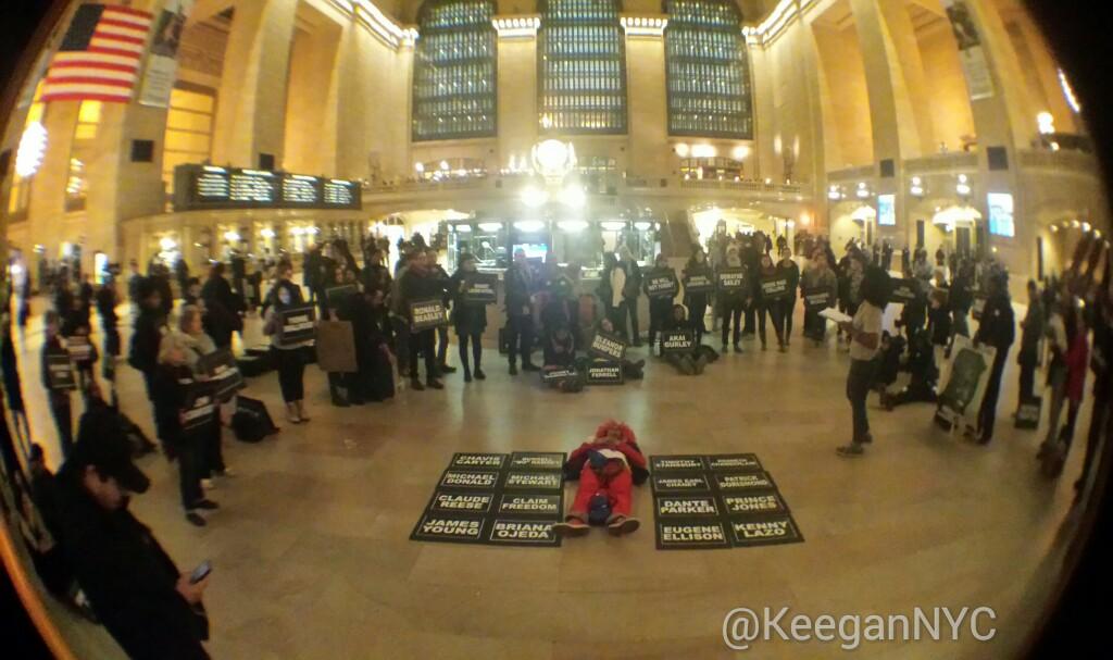 OccupyWallStNYC's tweet photo. Last week, the @MTA arrested @RevBillyTalen in #GrandCentral, citing lying down & laying signs down. #CarryTheNames http://t.co/b5pPMOqd2z