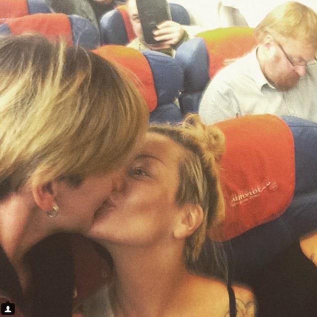 DailyMail's tweet photo. Lesbian couple take selfie in front of anti-LGBT politician on flight http://t.co/nwbwlU95Vr http://t.co/1j6eMxg7tU
