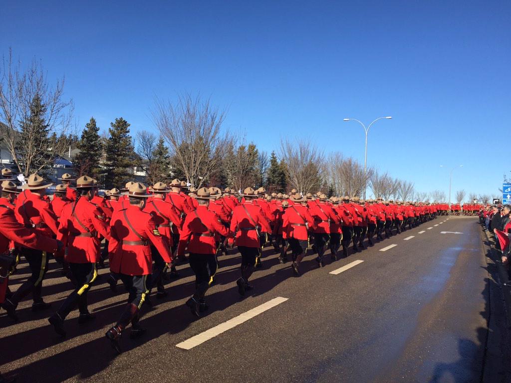 RCMPAlberta's tweet photo. #RCMP officers march to Servus Credit Union Place to honour Cst. David Wynn. http://t.co/sHDUeuuVjP