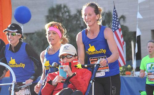 runnersworld's tweet photo. Twin pushes her disabled sister at the Miami Half Marathon: http://t.co/LnyjWV6kQq http://t.co/wydT7FZ2El