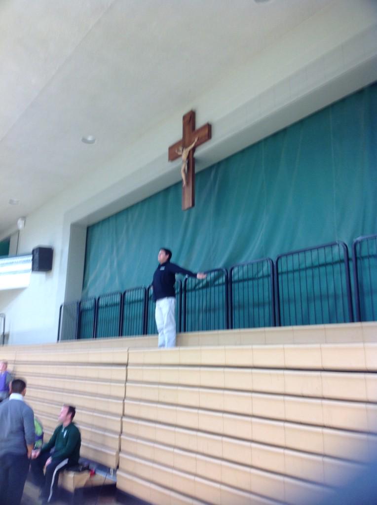 A huge crucifix in the gym above the stage displaying our Catholicism to all