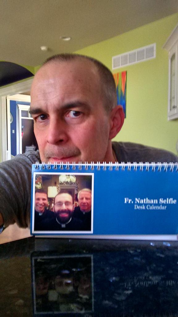 TheDaveHenke's tweet photo. A selfie with my Fr. Nathan Selfie Desk Calendar. Don't lie, you know you want one. #kcascension. http://t.co/YD7Ca0s7Lt