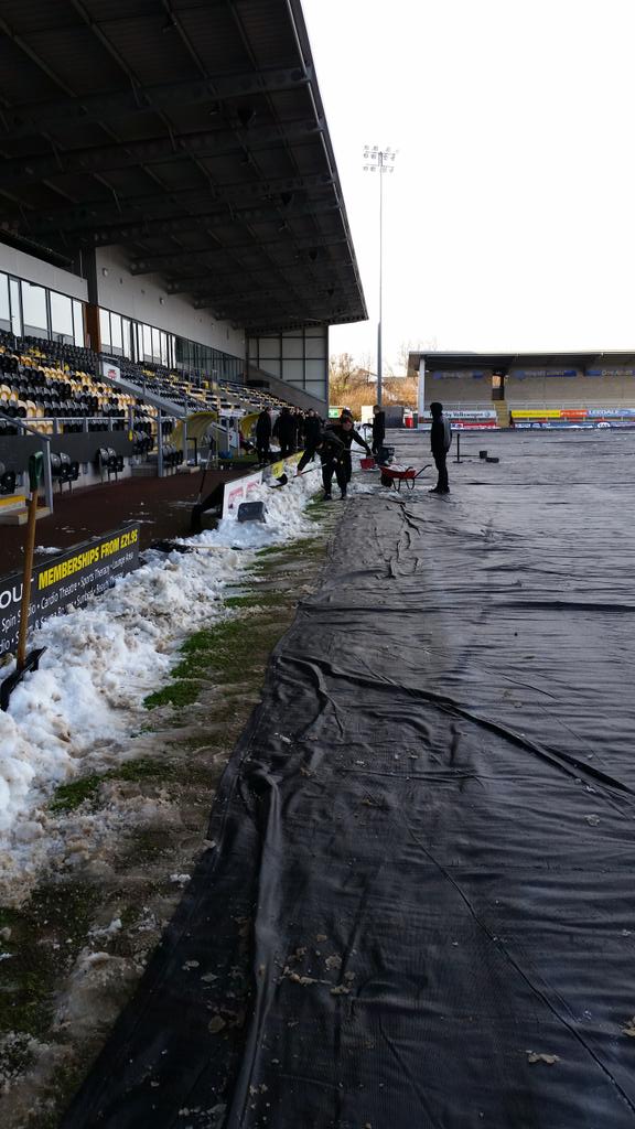 BurtonAlbionCT's tweet photo. Groundstaff and the academy players and staff are working hard to clear the pitch in preperation for tomorrows game! http://t.co/1OH5TzdkXf