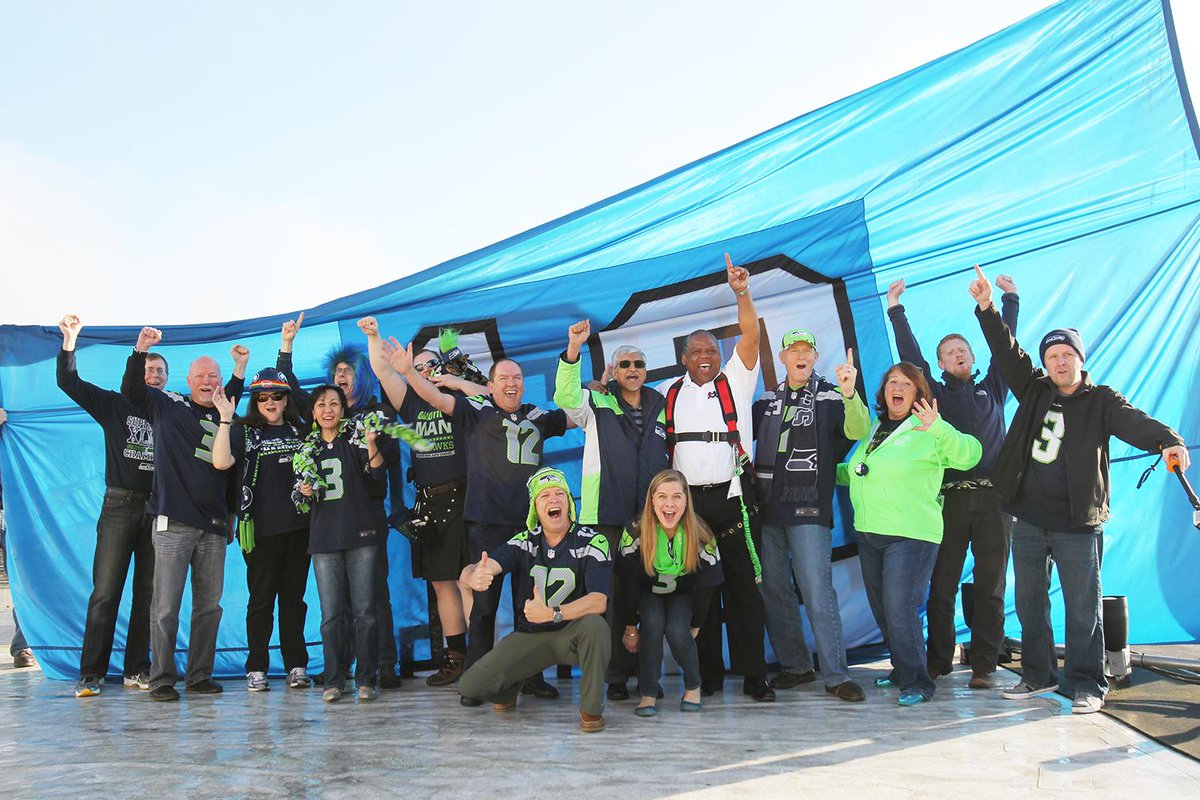 PSBJphoto's tweet photo. My lens, @PSBJ photos:  @PEMCO raises huge #12man flag on their rooftop in final #BlueFriday for #SeattleSeahawks http://t.co/dHIOScxDtr