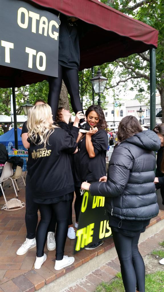 OtagoDancer's tweet photo. How many dancers does it take 2 hang a sign?#NoLadder #DancersSolution #Fun #USAHereWeCome #Disneyland #Cheerleaders http://t.co/LtEigLmvqH