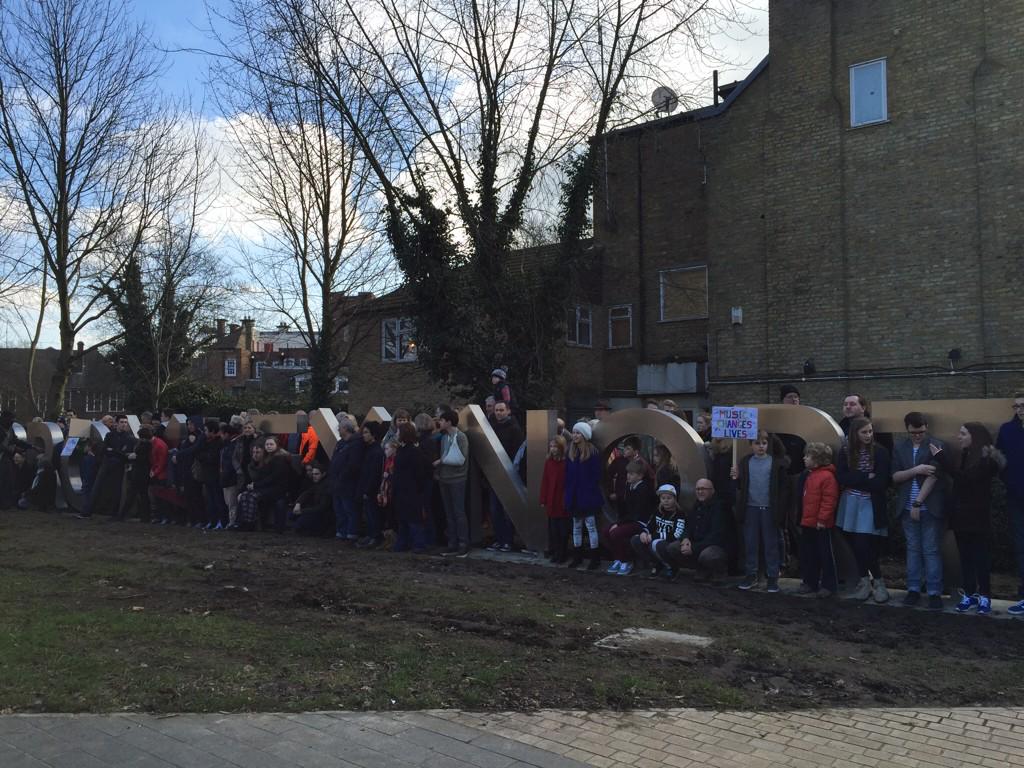 Ntsaldaraki's tweet photo. Protesters pose for @NewsShopper at new sign @LBofBromley cost 100K: the idiocy of public money misspent #saveBYMT http://t.co/383sHfhUc9