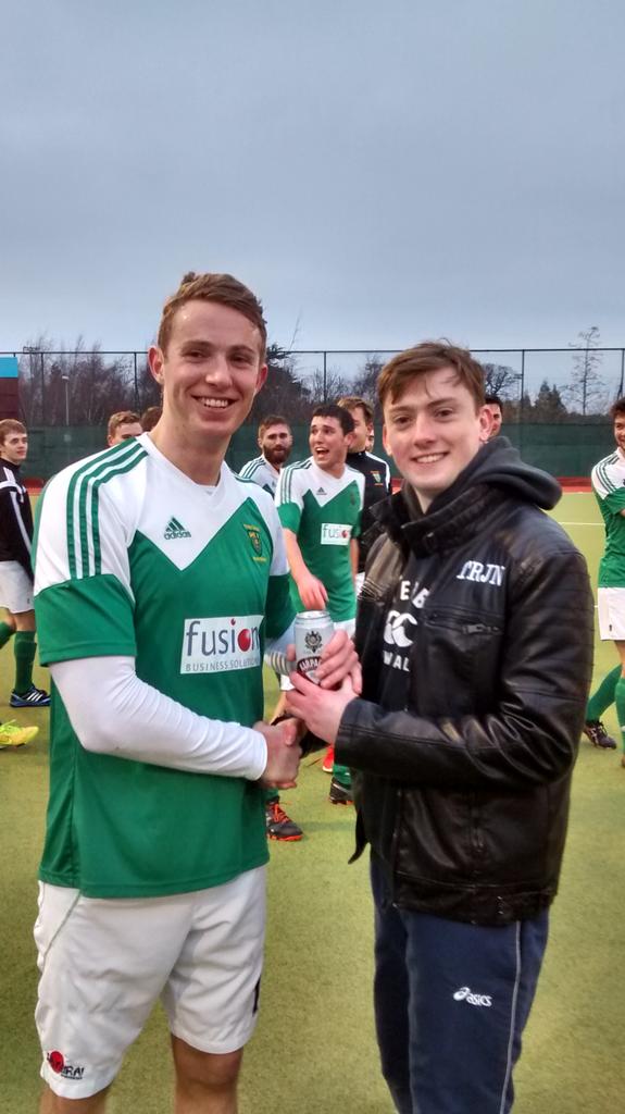 DUHCMens's tweet photo. Tom Crampton generously awarding the @TrinityTrojans4 can of the match to Steve Nolan  last Monday #Colours #TRJN http://t.co/zxXd4Uy3Ck