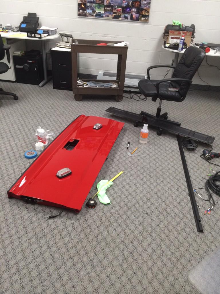 PriorityInstall's tweet photo. When you run out of room in the shop, you work in the office.  Applying graphics to a tailgate http://t.co/Gud4i4SWgV