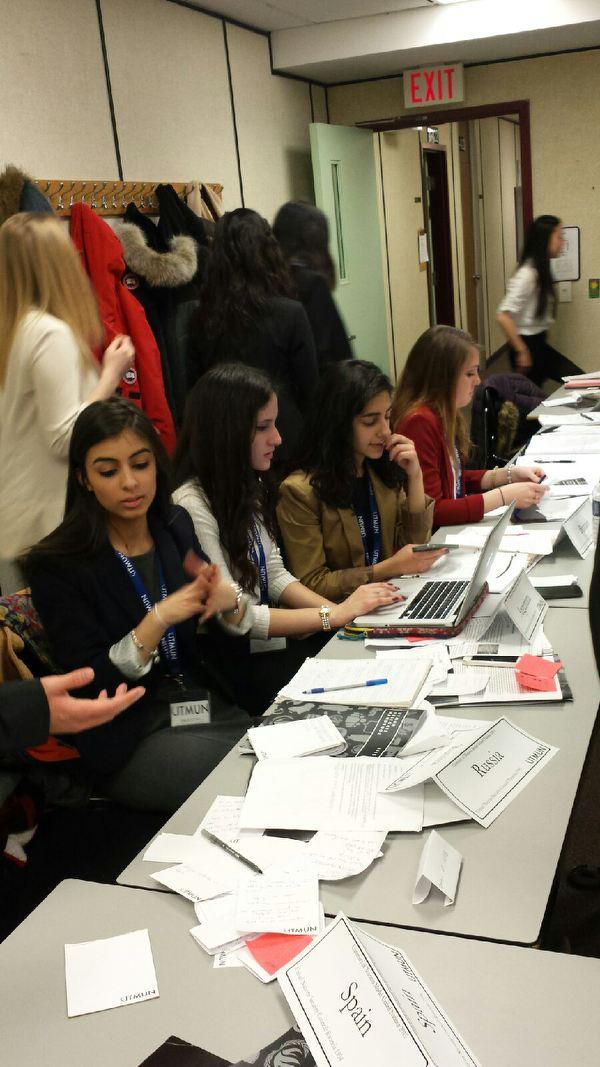 EleniHPapa's tweet photo. Working hard to draft a resolution for Rwanda #RHSSatUTMUN #UTMUN2015 http://t.co/nuJpxTjTE6