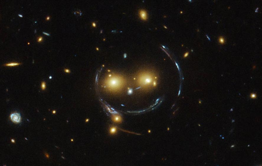 Discovery's tweet photo. Photo of the Day: Everyone seems to be talking about Hubble's amazing shot of the smiling galaxy cluster! via @NASA http://t.co/4MADFDUPHY