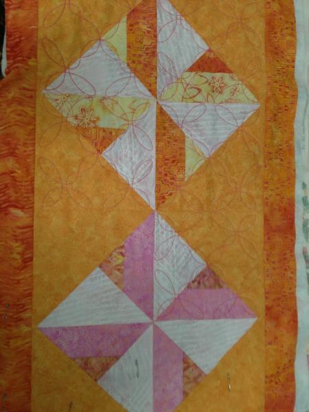 SERGE A LOT made a table runner from our quilt scraps !! Now practicing quilting in the hoop on the BabyLock Ellisimo.