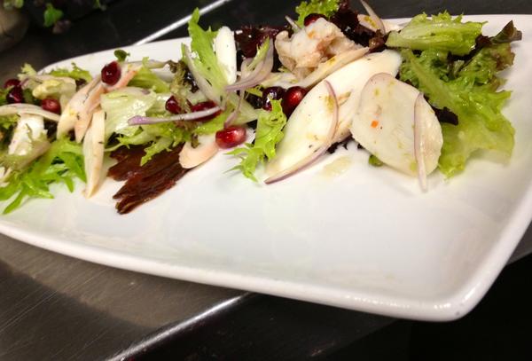 Octopus ceviche with dates, pomegranate and mixed greens in a lime vinaigrette