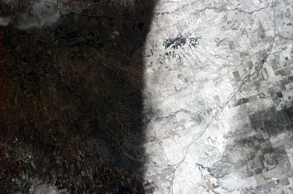 Cmdr_Hadfield's tweet photo. A snowstorm left a clear divide in the Southwestern US in January. A natural yin and yang on the prairie. http://t.co/pxc9PNWT