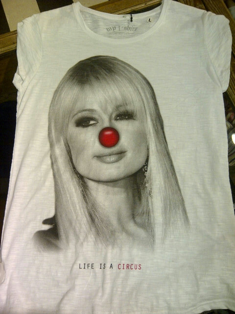 Clinictweets's tweet photo. Heard that @ParisHilton will be in Belgium tonight. Maybe she should drop by to get this shirt. #Clinic #lifeisacircus http://t.co/3kCPjqrm
